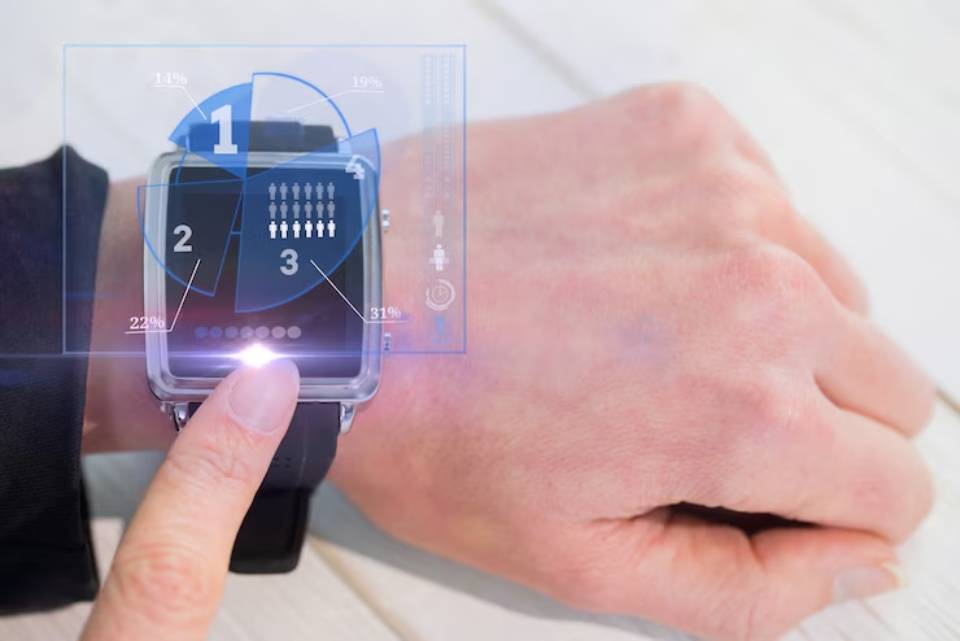 A close-up of a person's hand tapping a smartwatch displaying graphs and statistics over a light background.